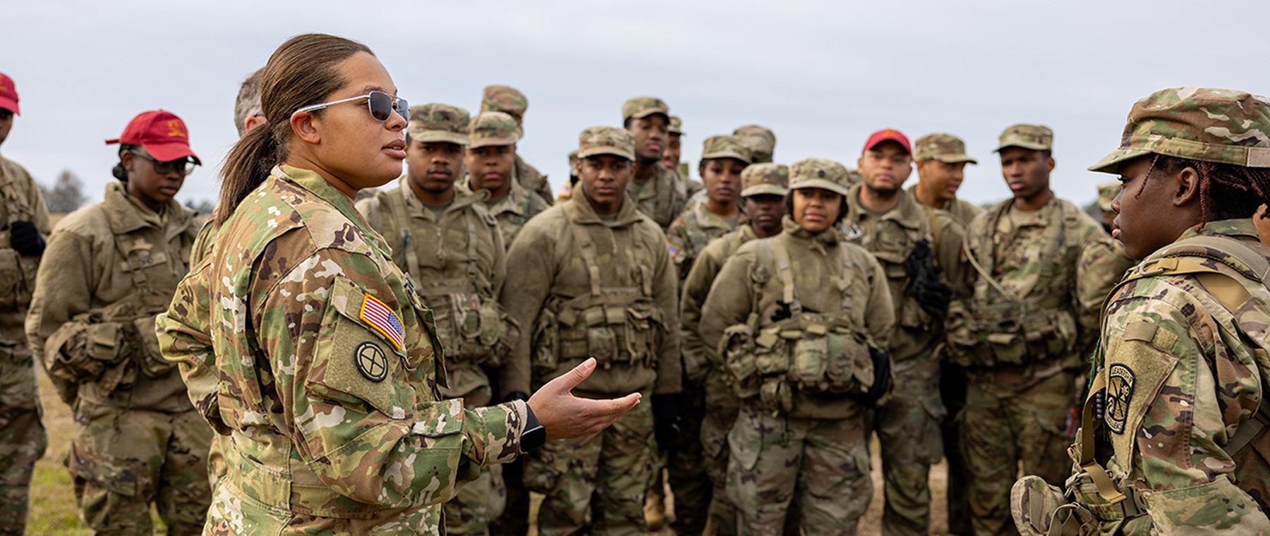TU alumna pilot speaking to group of ROTC cadets and leaders