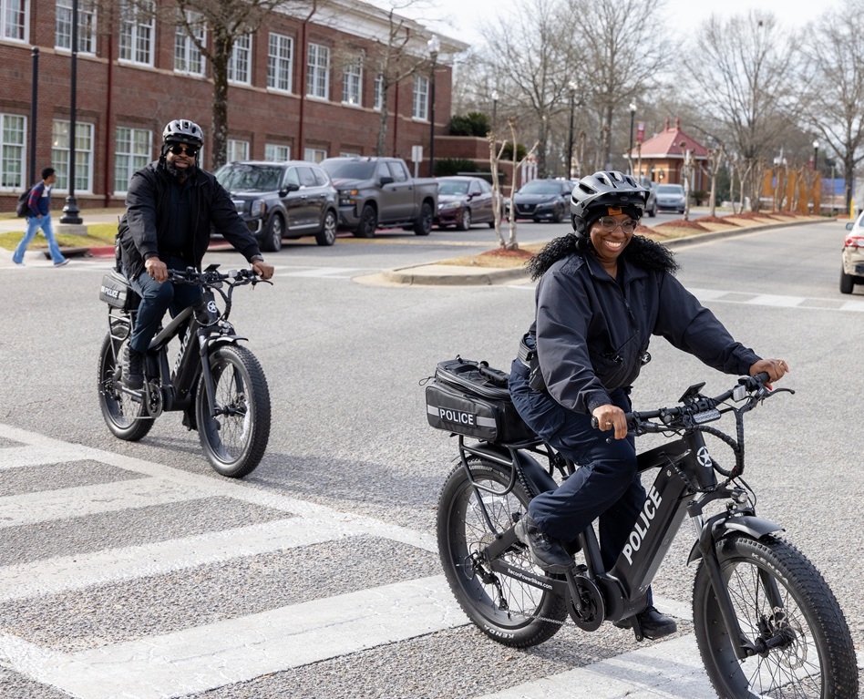 Two Bike Patrol Officers riding through campus