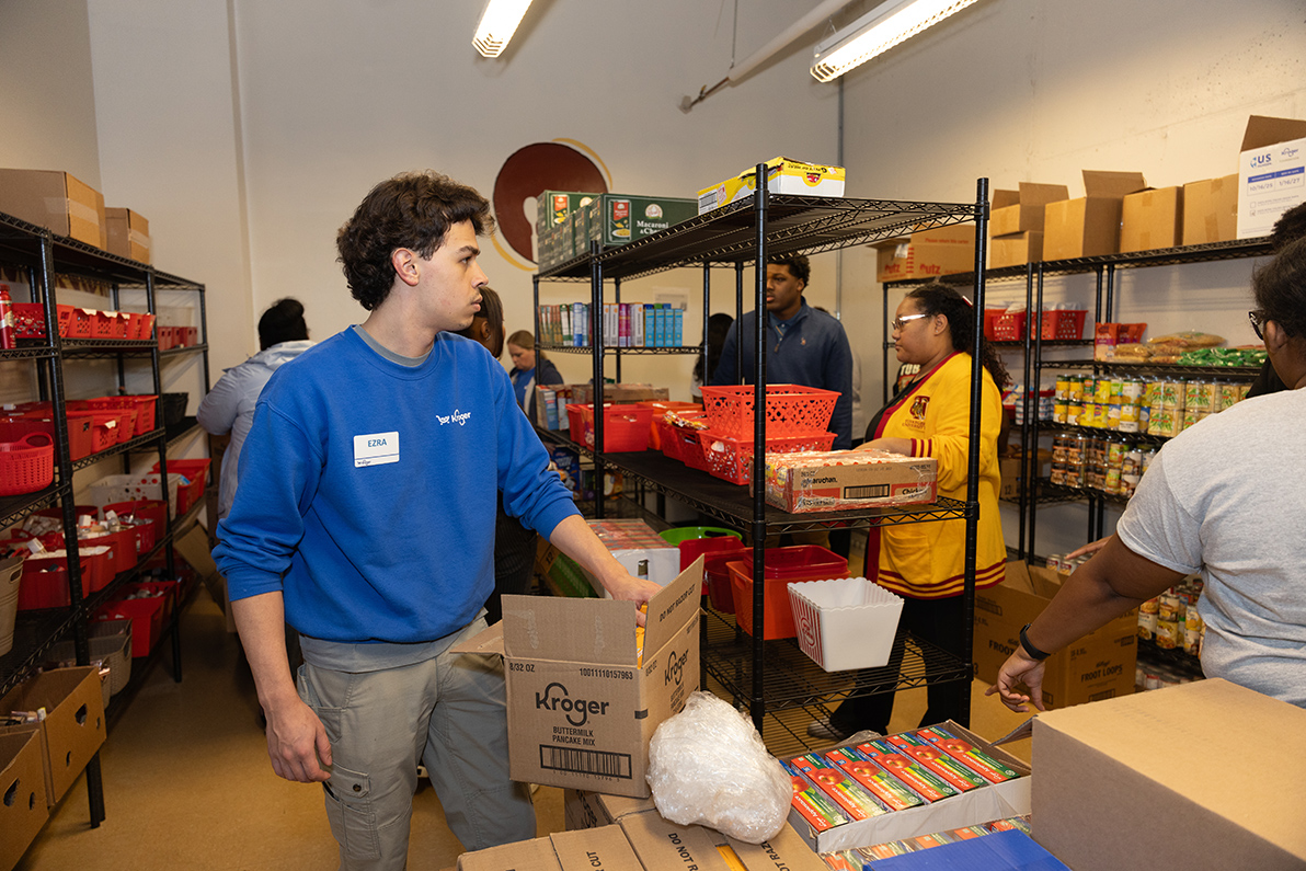 Workers unpack and stack the items on the shelves