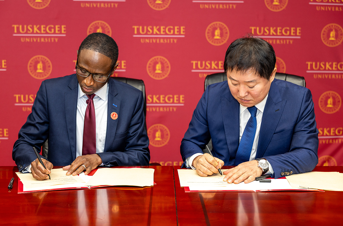 Jinwoo Kim, Samkwang president and CEO signs document with Dr. Thierno Thiam, TU Provost