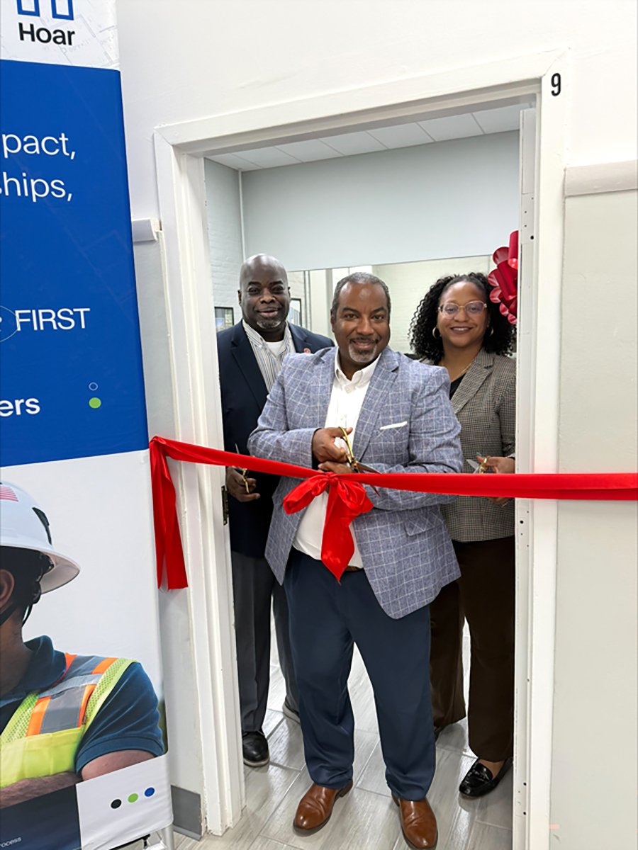 TSACS Dean, Construction Dept Head, and Hoar representative cut ribbon