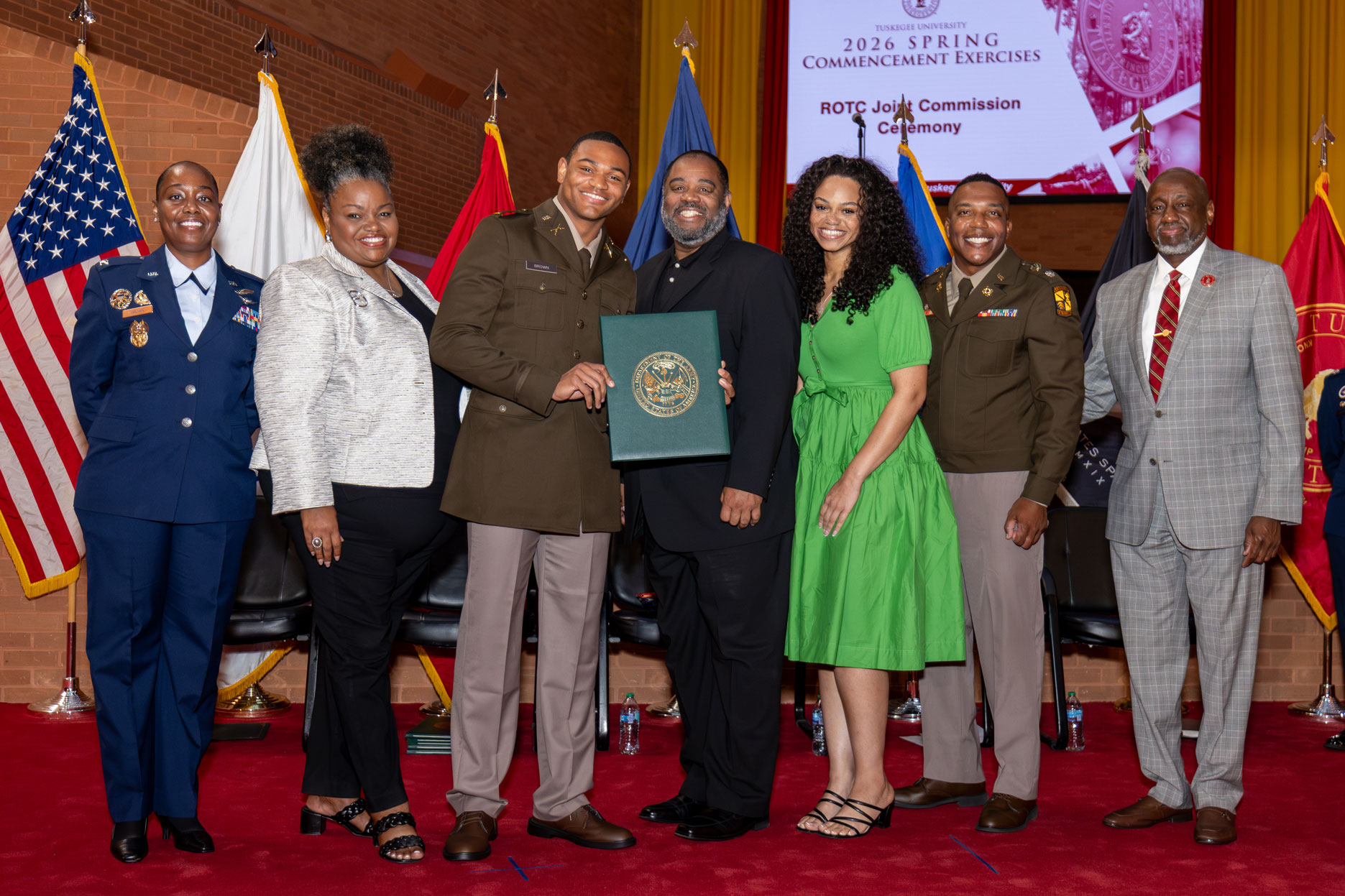 ROTC Commissioning speaker, platform guests and cadet with his family