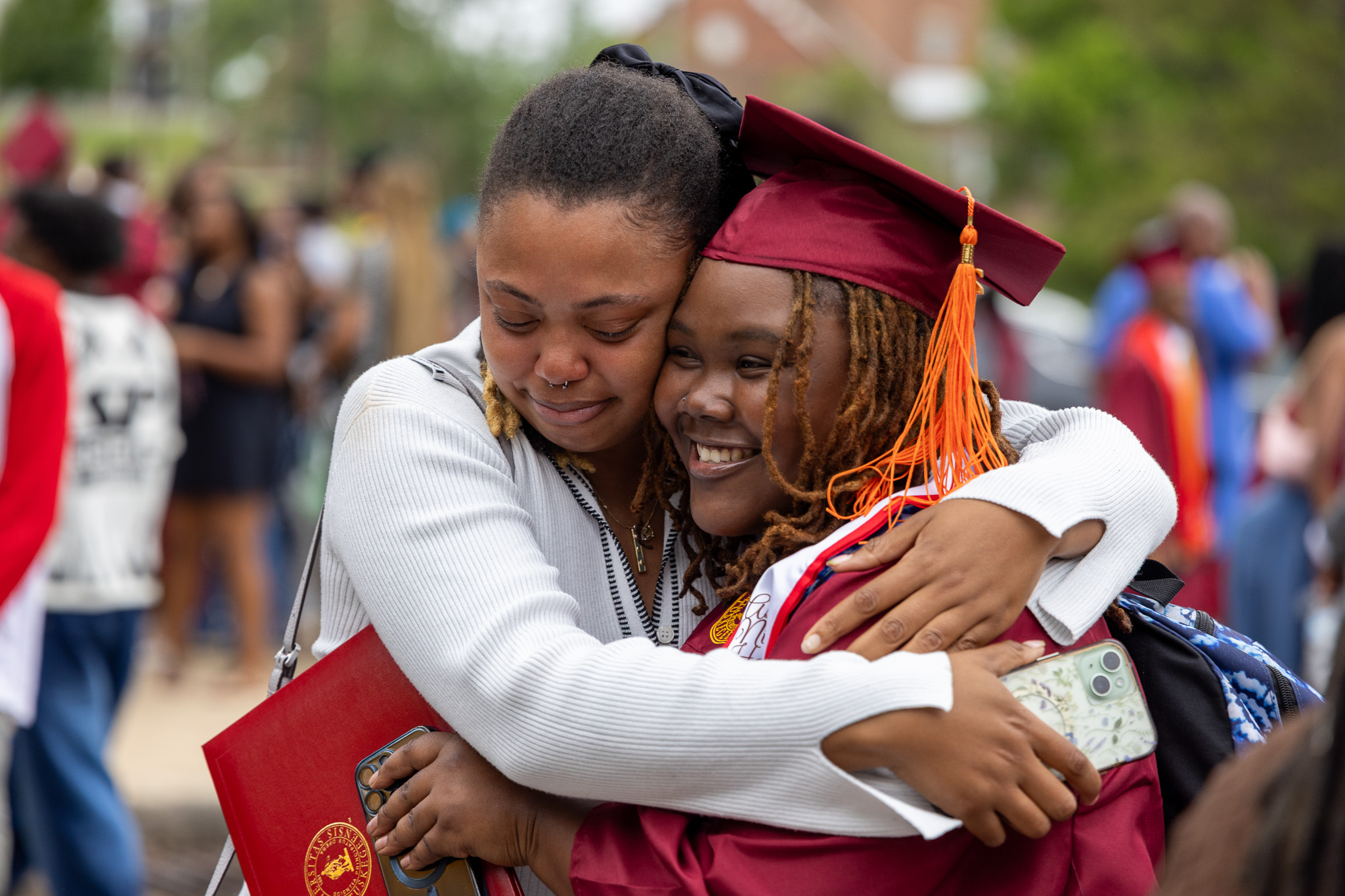 Parent hugs a female graduate