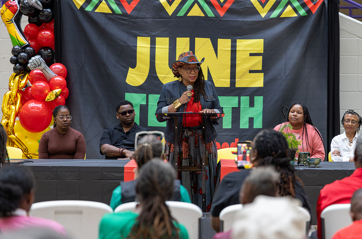 Dr. Rachanice Tate speaking at podium during Juneteenth event