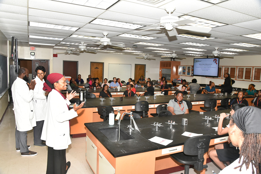Student in science lab asking questions