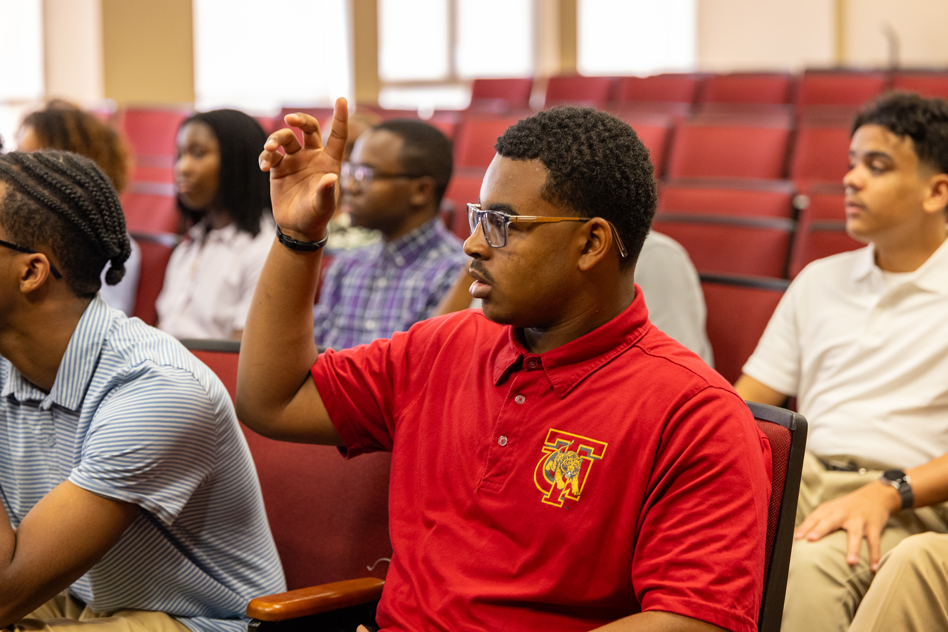 Student raising hand asking question
