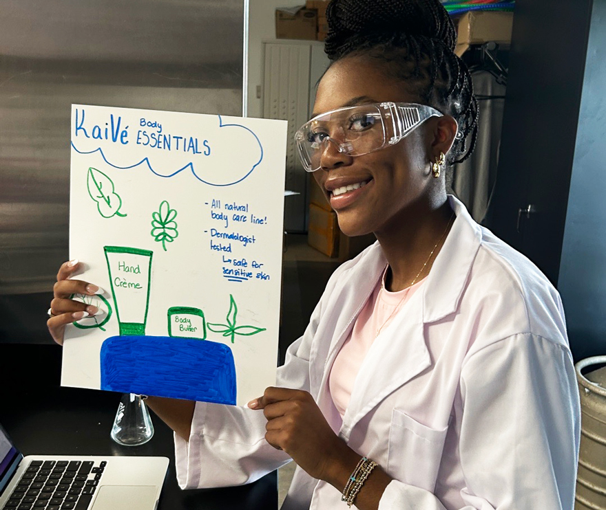 Student in lab holding up paper