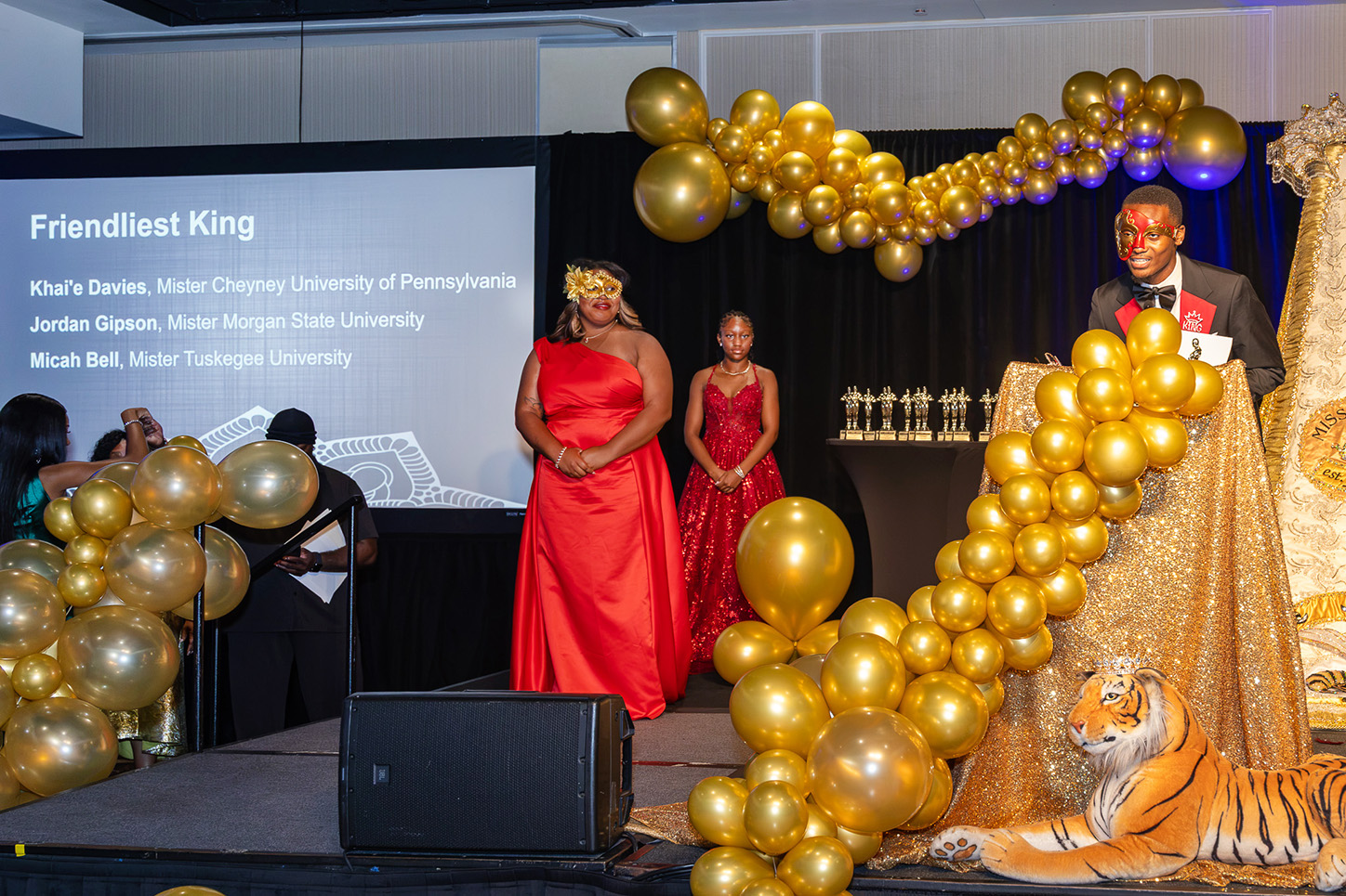 TU Royal Court giving presentation at masquerade ball.