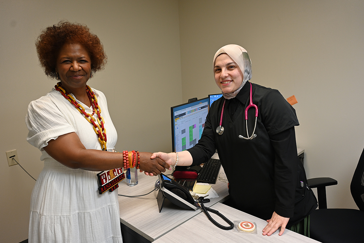 Mrs. Brown greets a staff member
