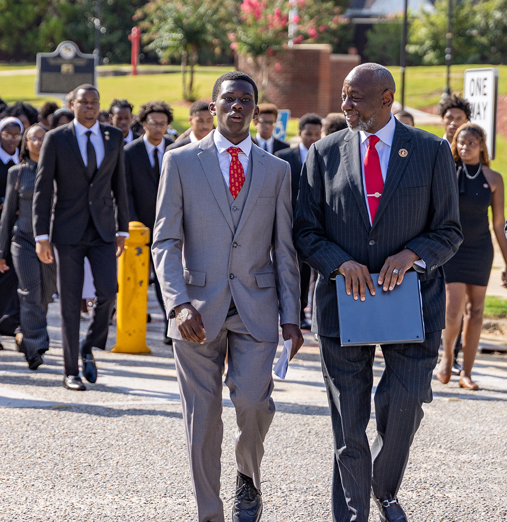 Dr. Brown talking with new student as they walk to the Chappie James Center