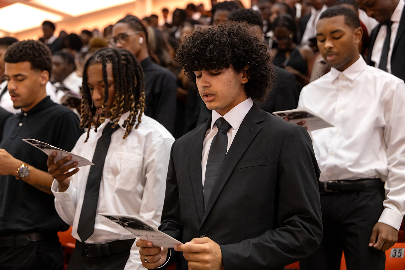 New students reading during the Rites of Passage ceremony