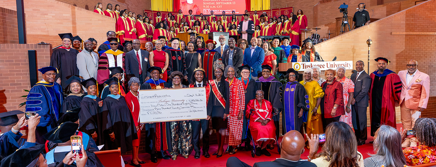 Eminent Associates present $4.1 million check for the university to Dr. Mark A. Brown during Fall Convocation 2026