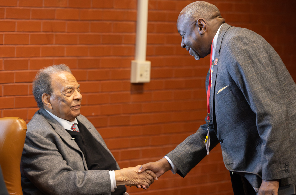 Ambassador Andrew Young shakes hand with Dr. Mark A. Brown