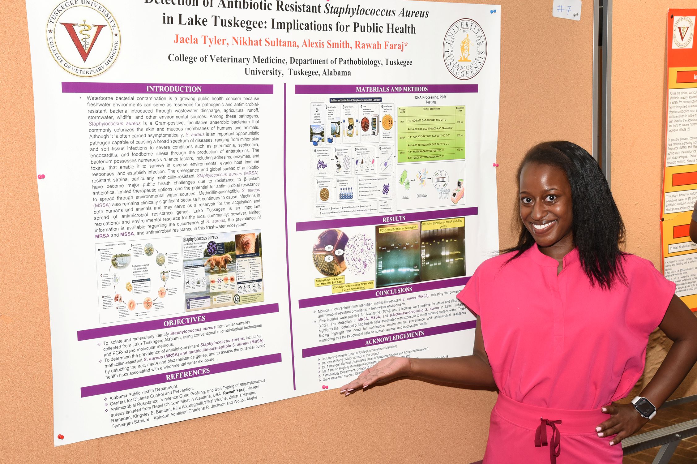 A student doing her posted presentation