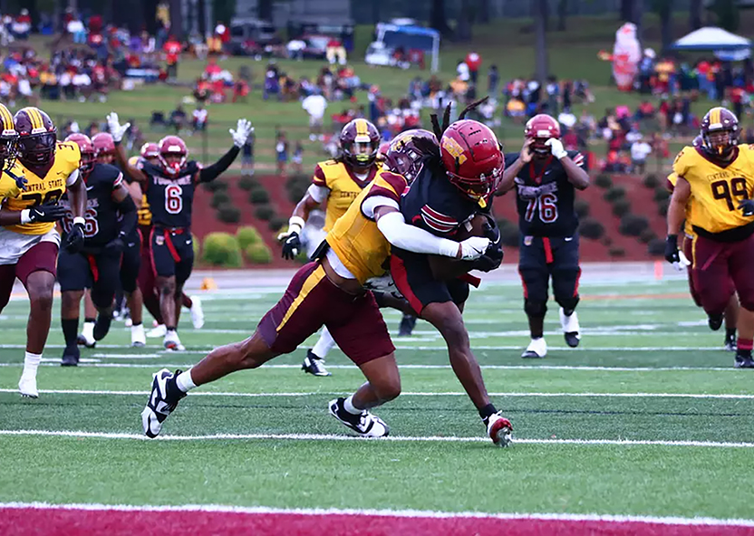 Players tackling at football game - Tuskegee University's first night game