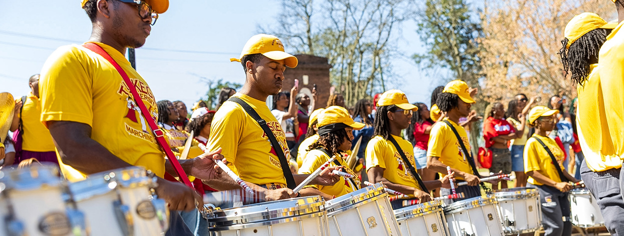 TU Band in yellow shirts and caps performing at Open House