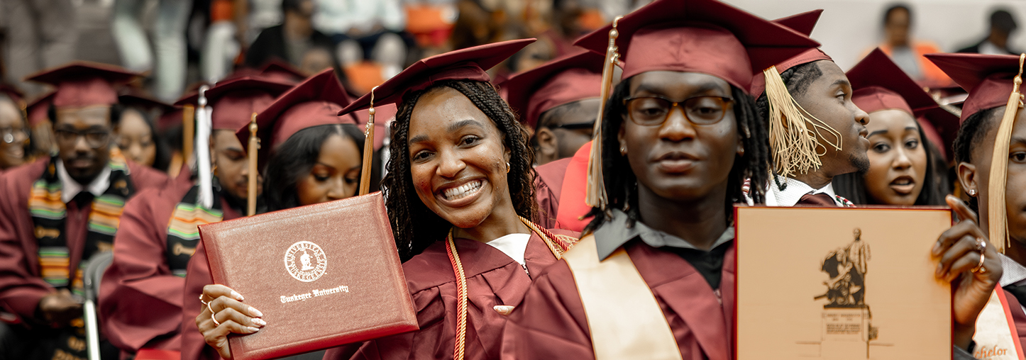 Students showing their diplomas at Commencement