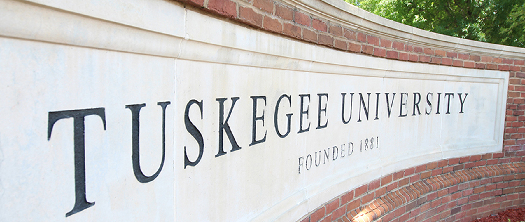 TU name sign at the entrance to campus