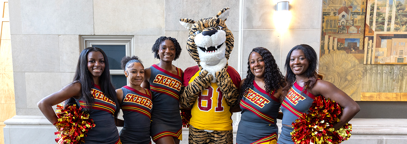 A few of the cheerleaders with mascot