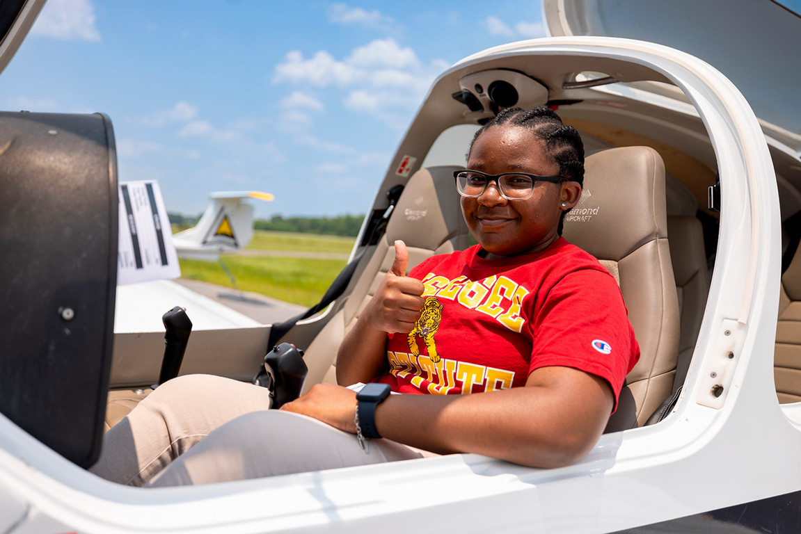 Female student in the cockpit of a small plane
