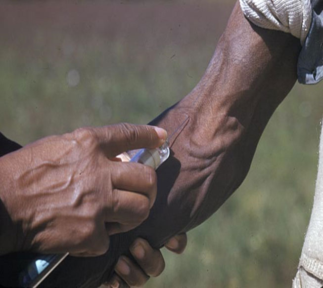 Picture of a hand injecting another hand