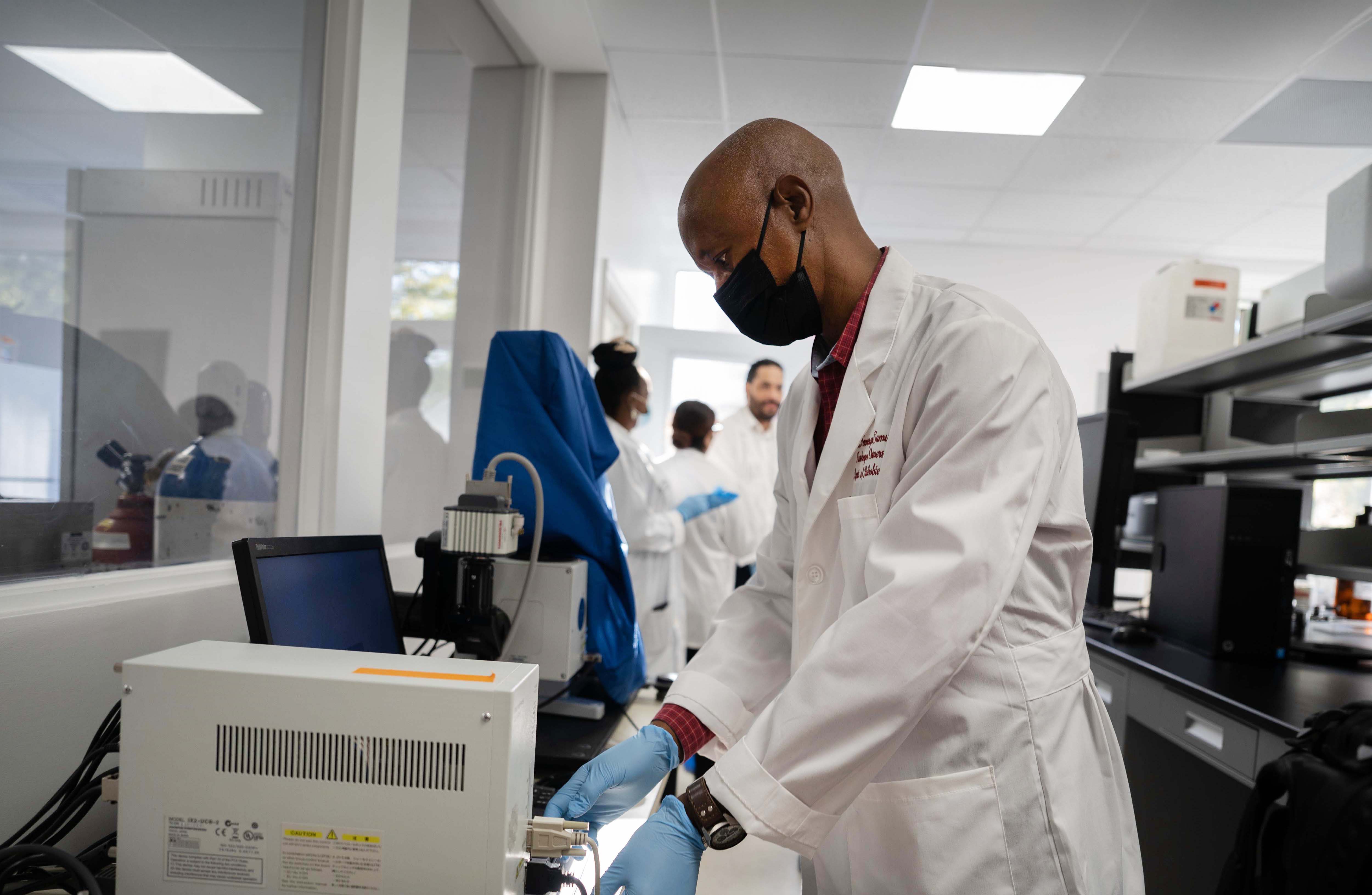 Male researcher operating apparatus