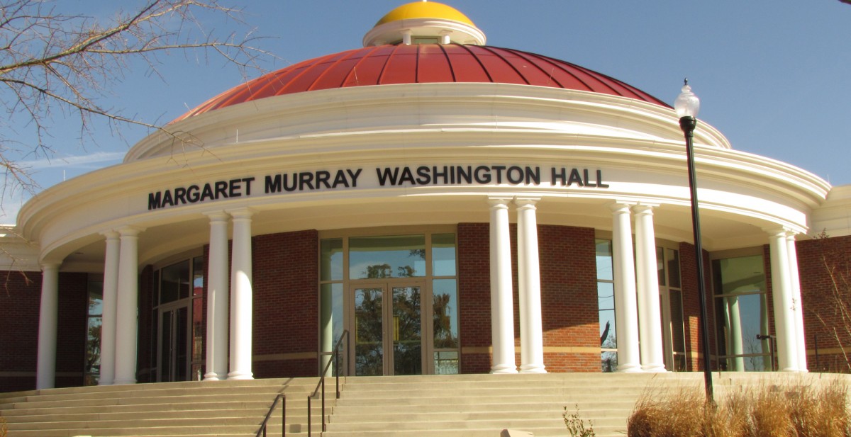 Front entrance of Margaret Murray Washington Hall, a round brick building with white columns and a red dome.