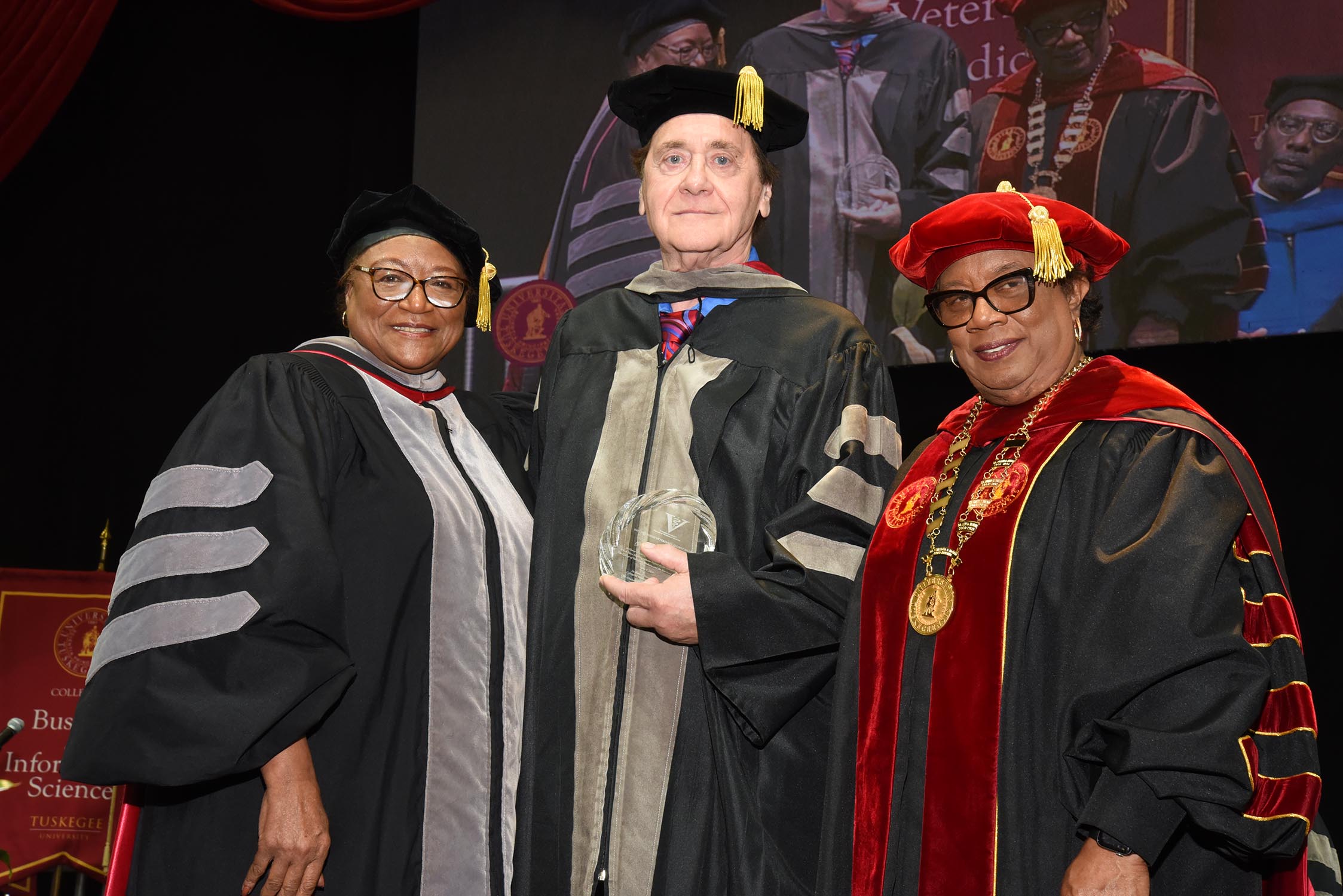 Dr. Daniel Negola (center) receives award from Dean Perry and President Morris.