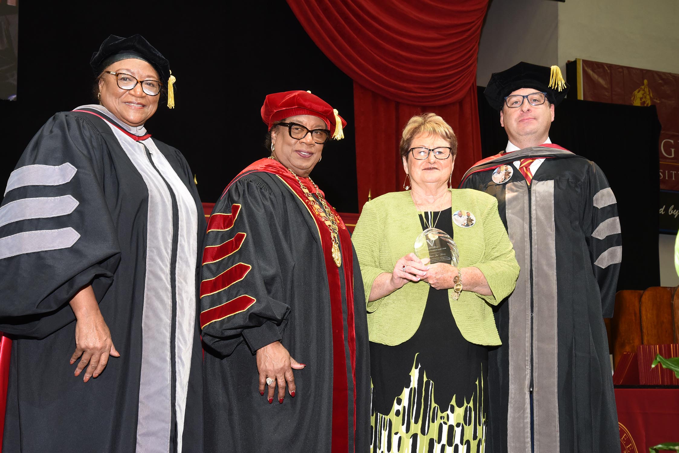 The Family of Dr. James Heintz receives his award from Dean Perry and President Morris.