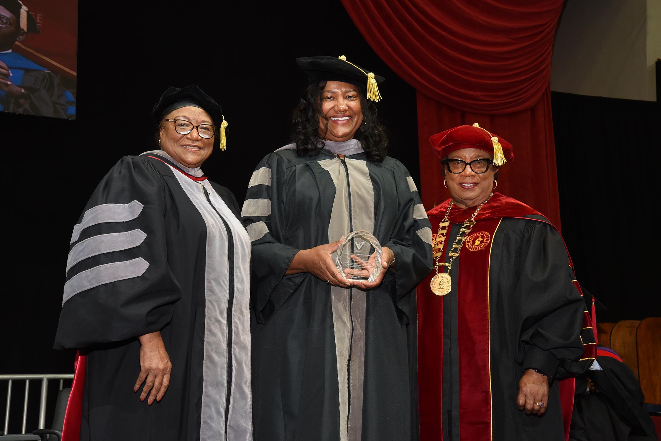 Dean Perry and President Morris present award to Veterinary Oath speaker, Dr. Carla Gartrell.