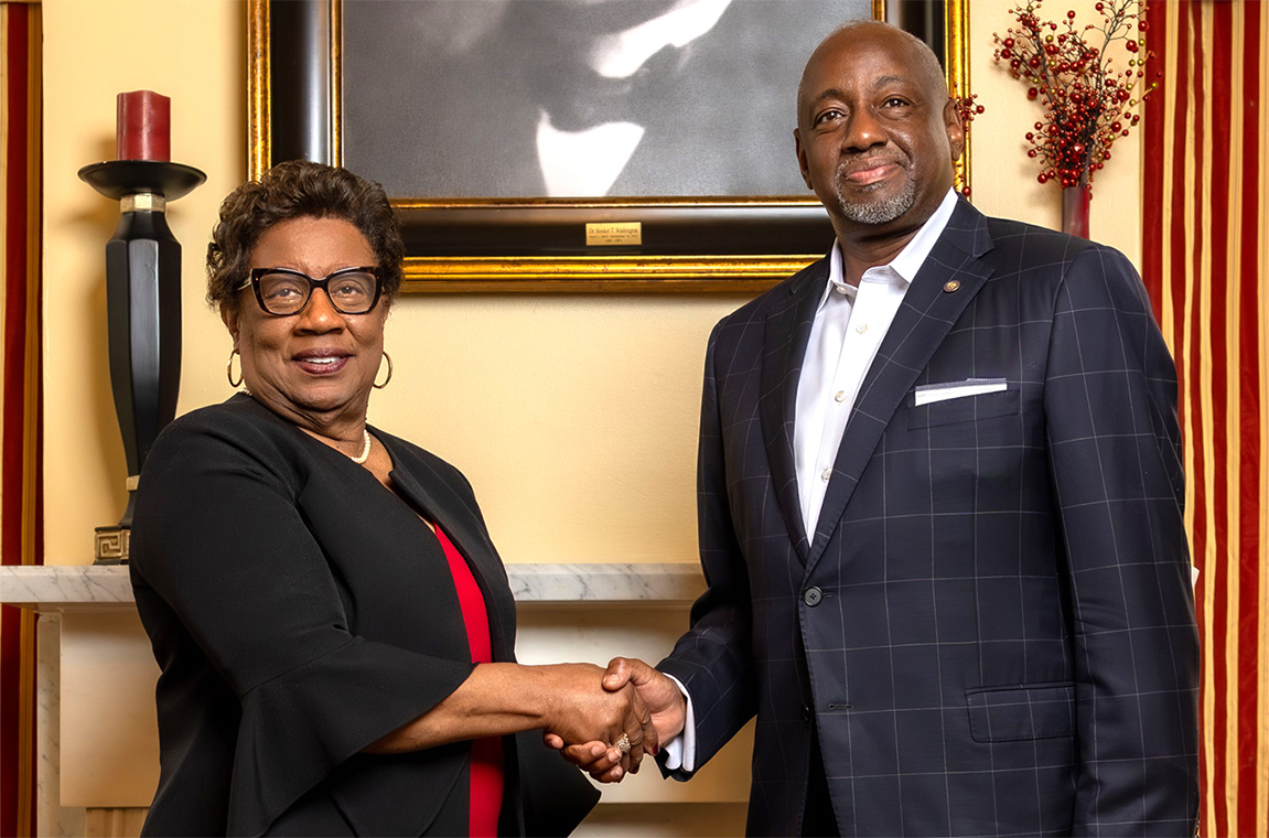 Dr. Charlotte P. Morris and Dr. Mark Brown shaking hands