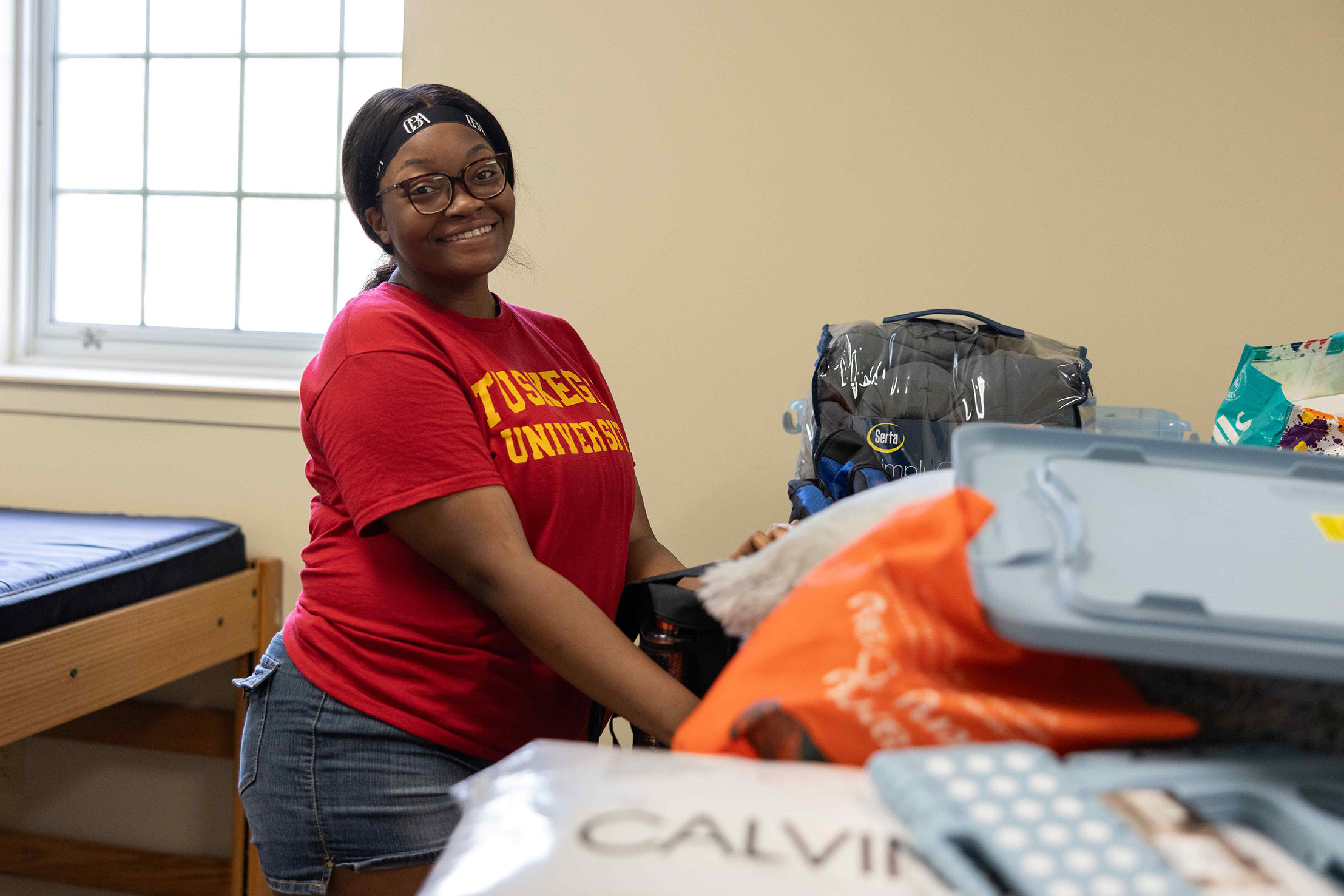 Student arranging items inside her room.