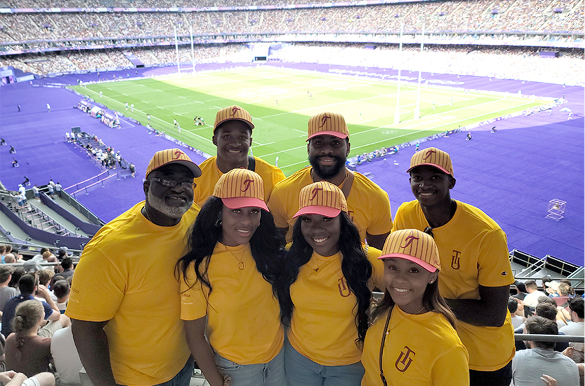 TU Students and chaperone at an Olympics game stadium.