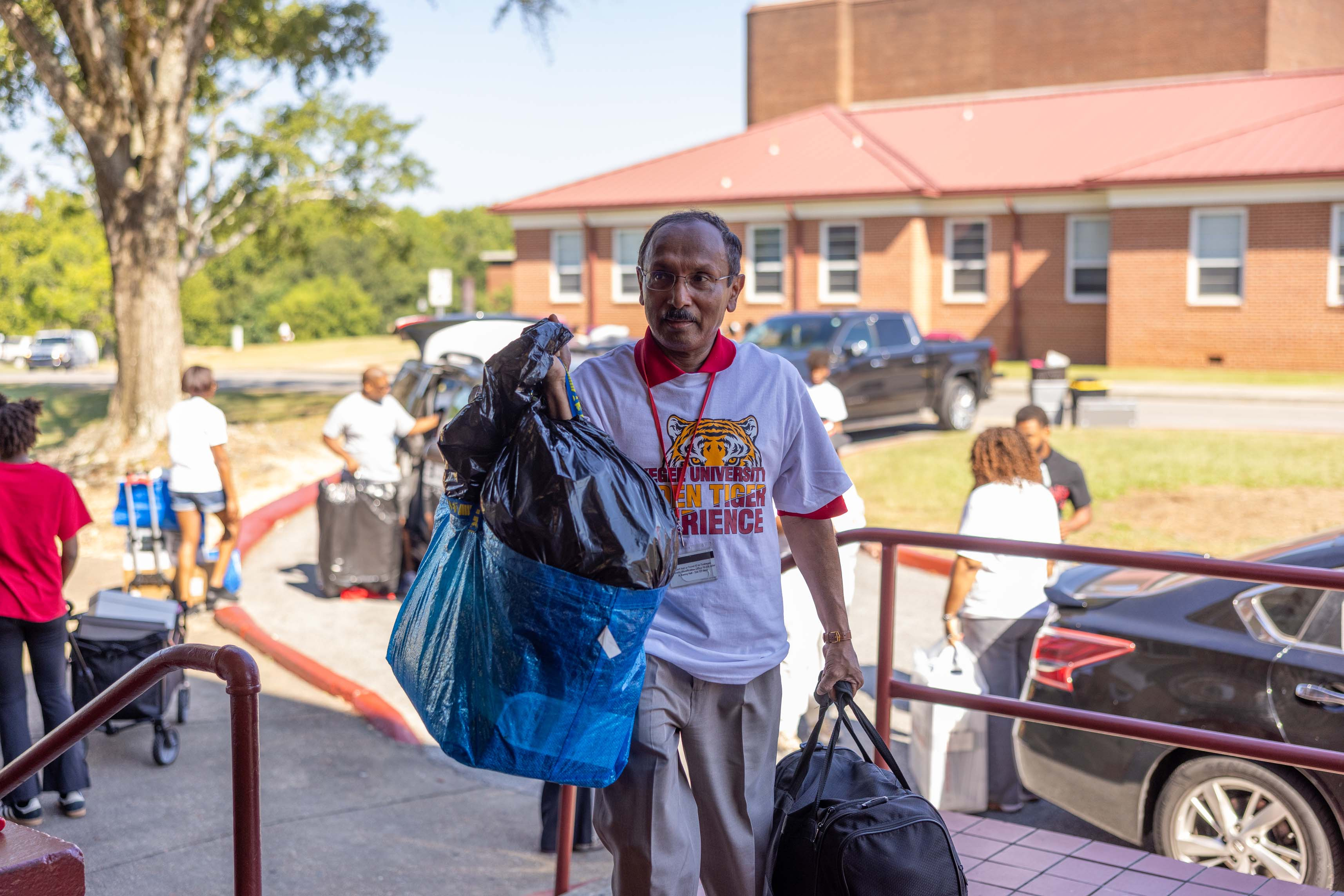 CIO Abraham George assists students with carrying items.