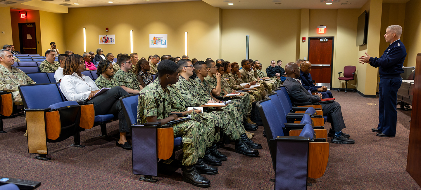 General Timothy D. Haugh speaks to cadets in Brimmer Hall auditorium.
