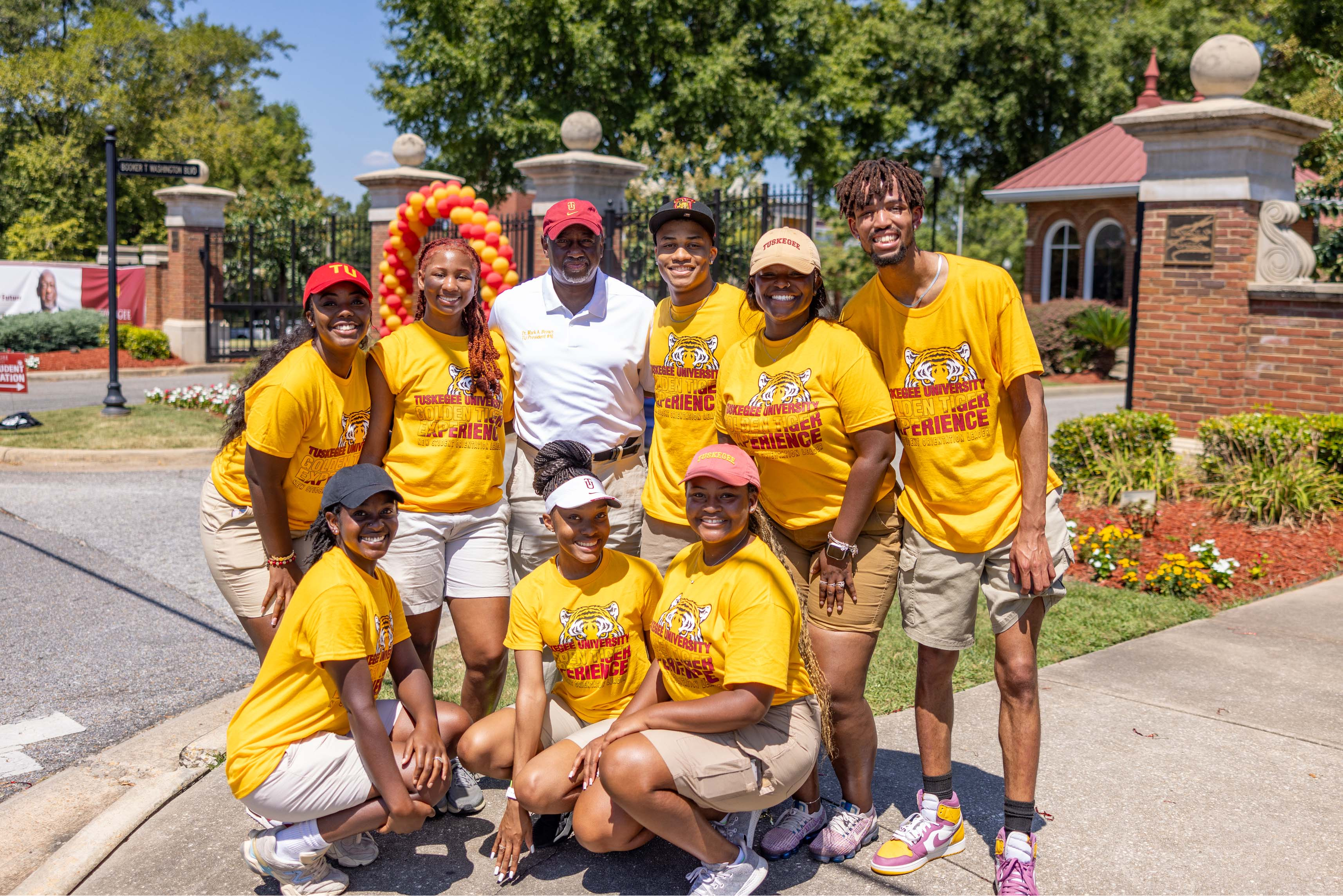 President Brown poses with greeters at the main gate.
