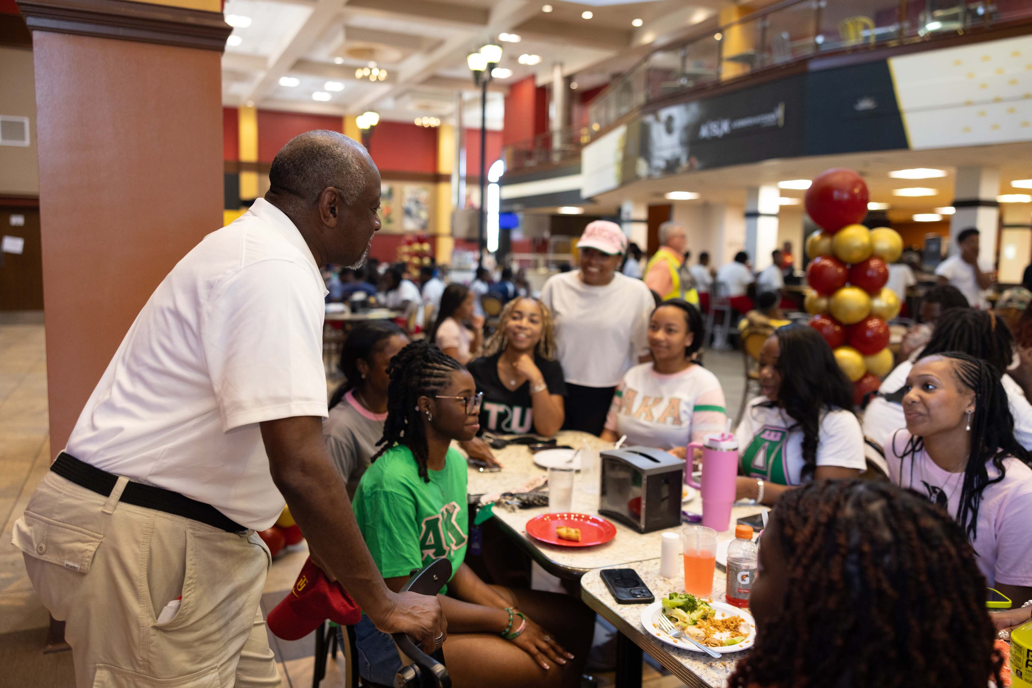 President Brown talks with students in the cafeteria.