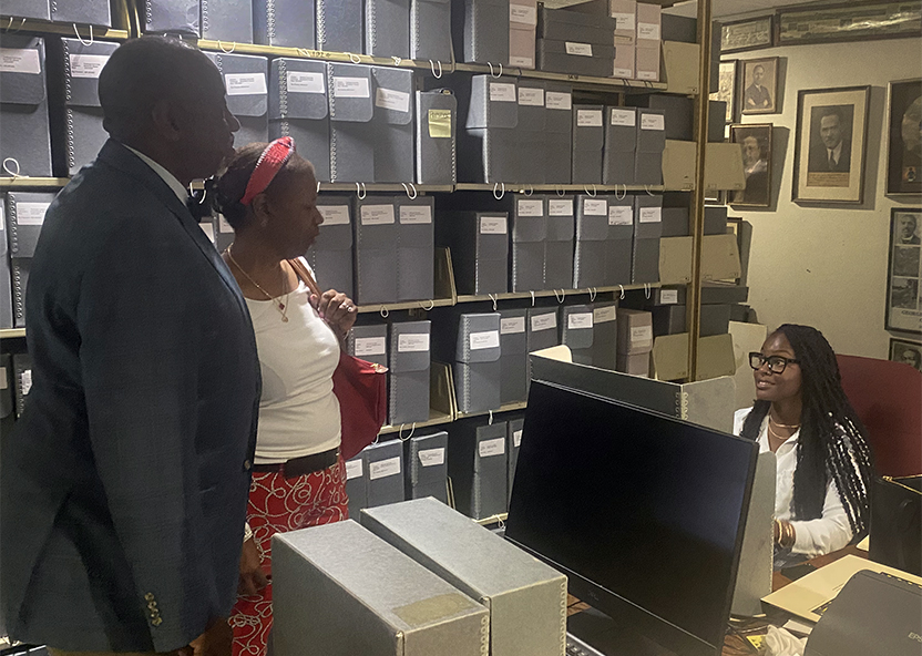 TU President Dr. Mark Brown and First Lady Gwen Brown in the Tuskegee University Archives talking with student intern Karin Barnes.