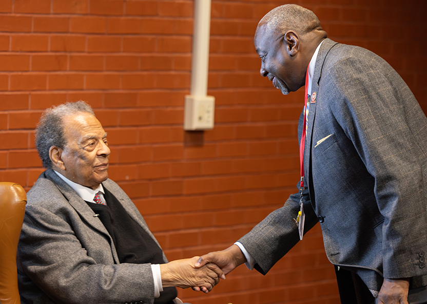 U President Dr Mark Brown shakes hands with Ambassador Andrew Young.