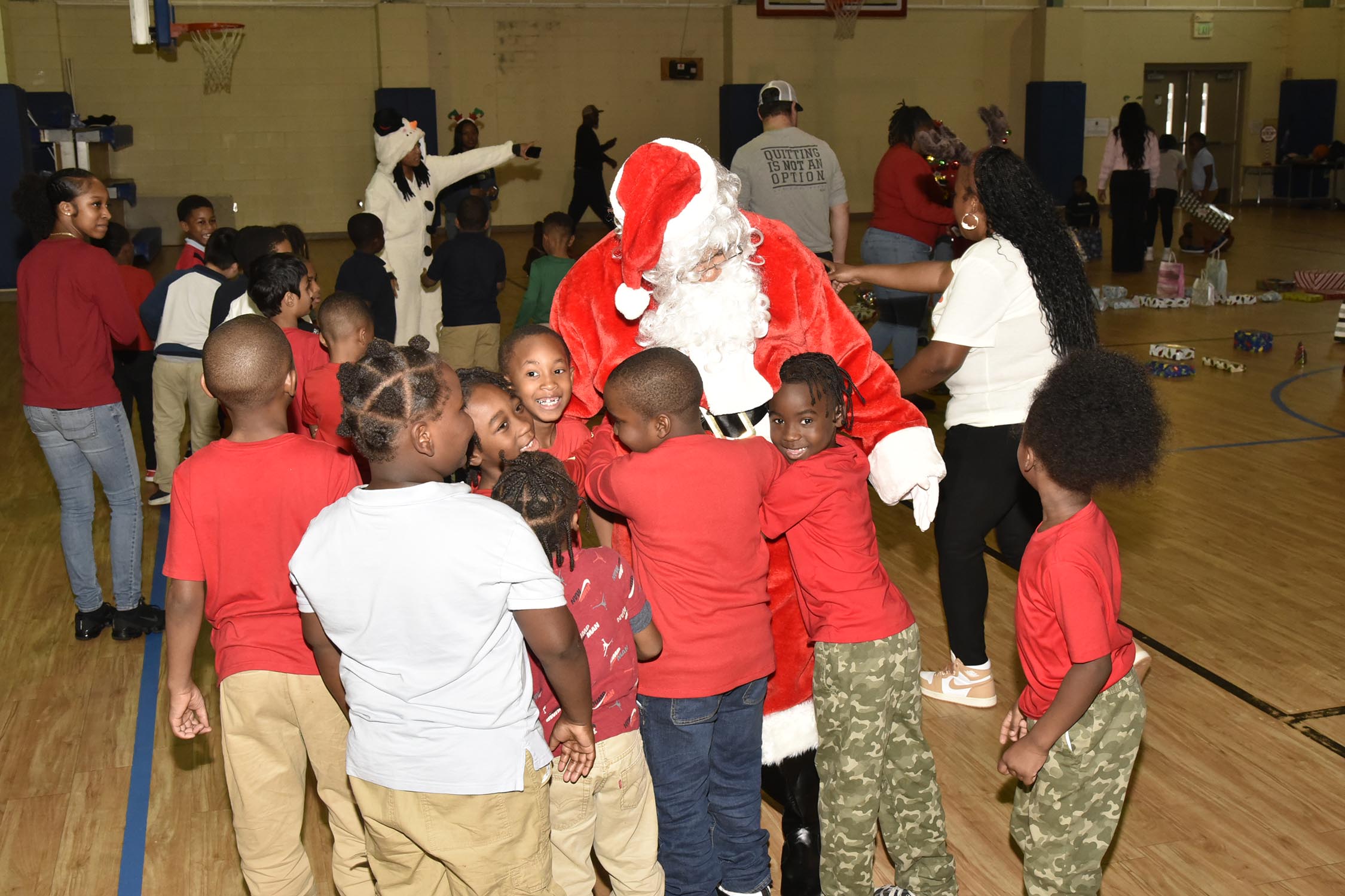 Santa with children at Vet Med Toy Drive at Carver Elementary School.