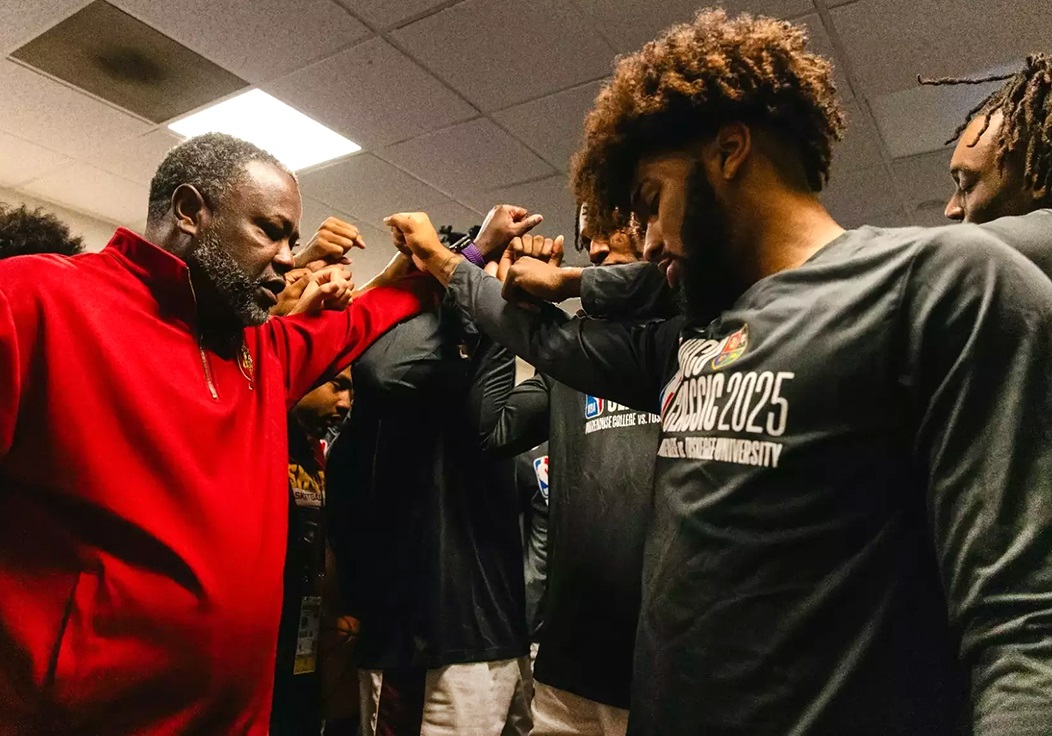 TU Men's Basketball Head Coach and Team in huddle.