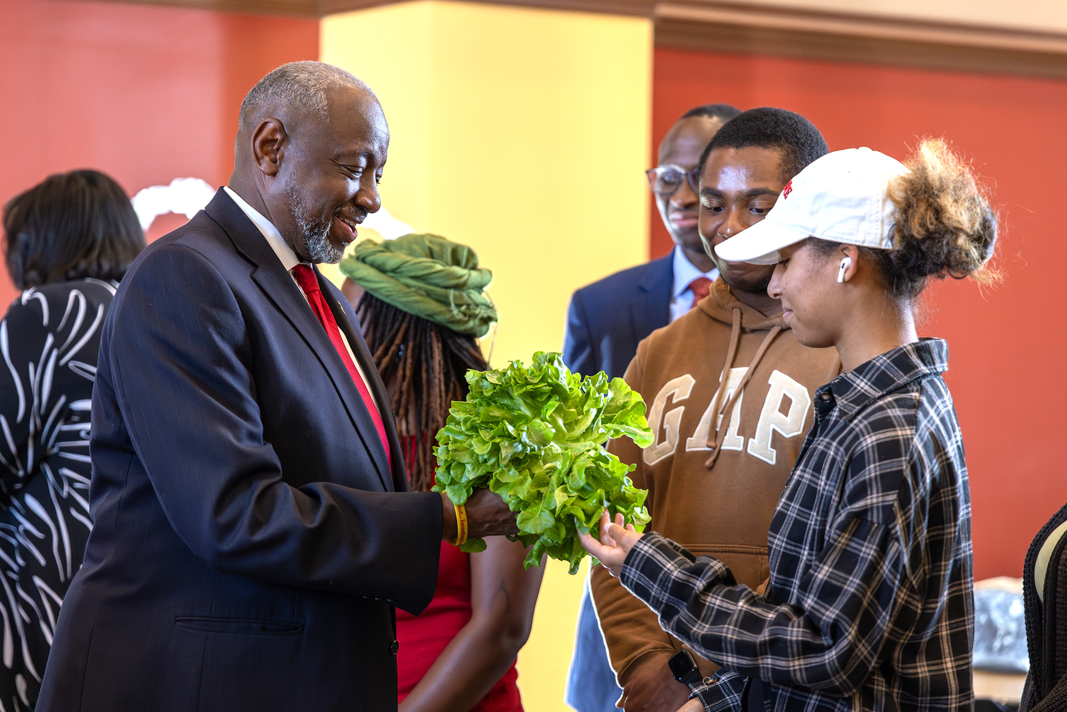 Dr Brown and student examine fresh greens