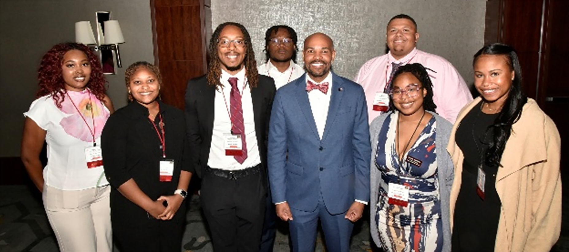 Keynote speaker and 20th Surgeon General Dr. Jerome Adams (center) engages with veterinary students and student leaders after his presentation.