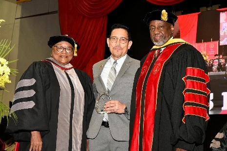 Dr. Nelson Diaz receives awards for Drs. Bernardino Ortiz and Vera A. Burrell (not in attendance)