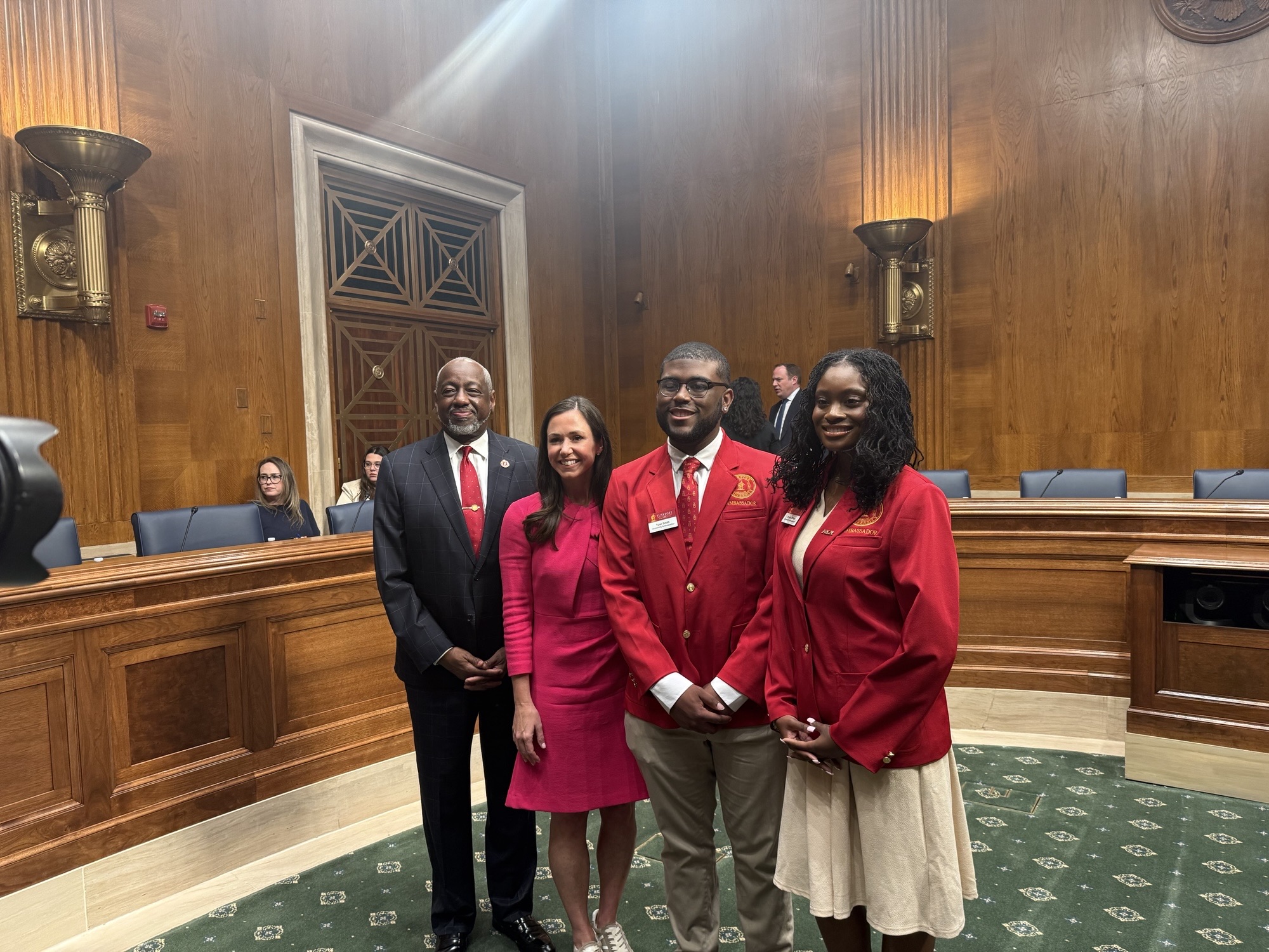 Dr. Mark A. Brown at Senate hearing with Senator Katie Britt, and TU Student Ambassadors Tyler Smith and Aryial O'Neal.