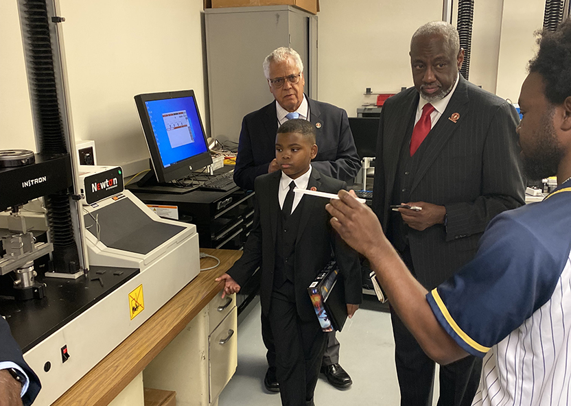 President Brown and Jaidyn visit a lab.
