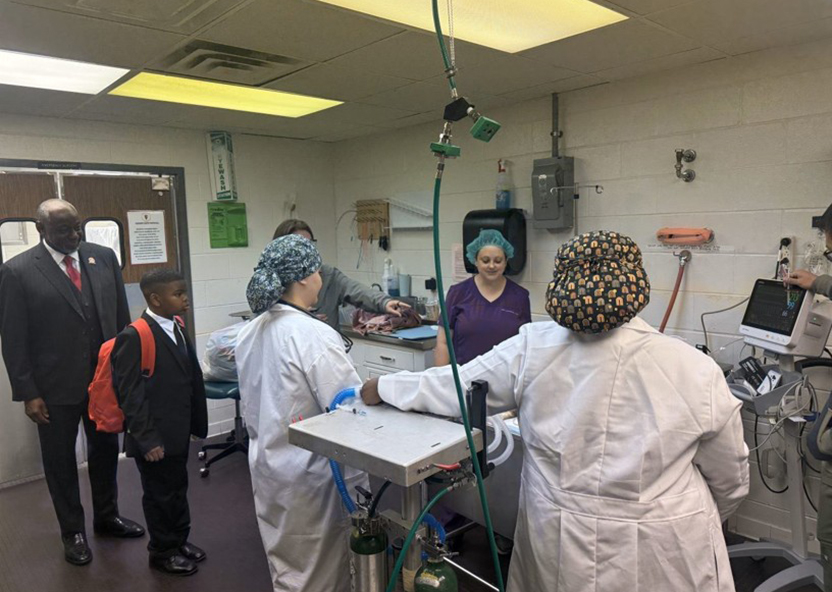 President Brown and Jaidyn watch a procedure in the Vet. Clinic.