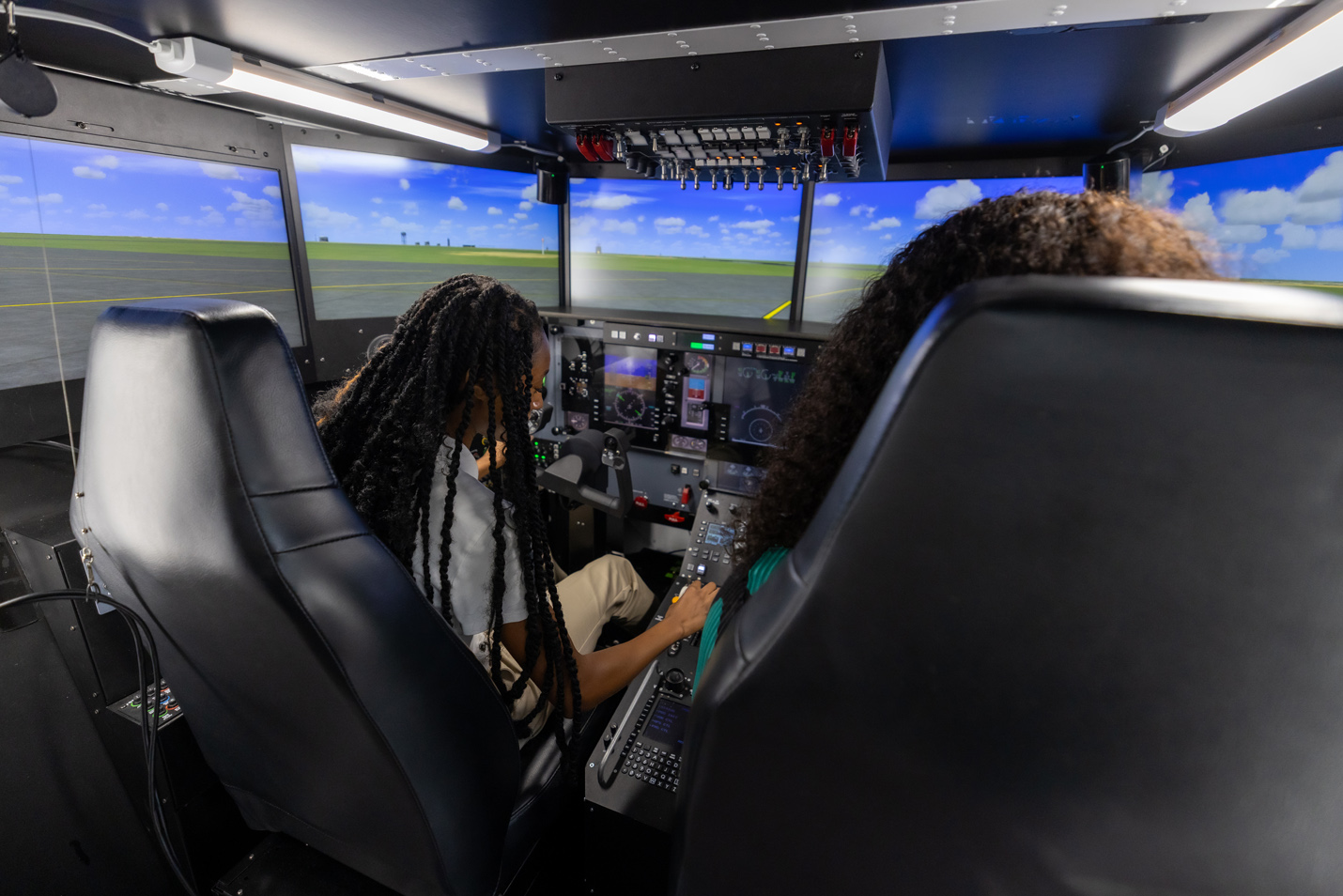 Students try out the flight simulator.