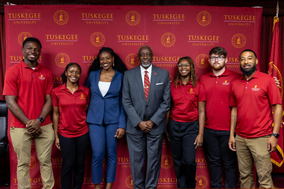 Dr. Mark Brown poses with Internship students and alumna