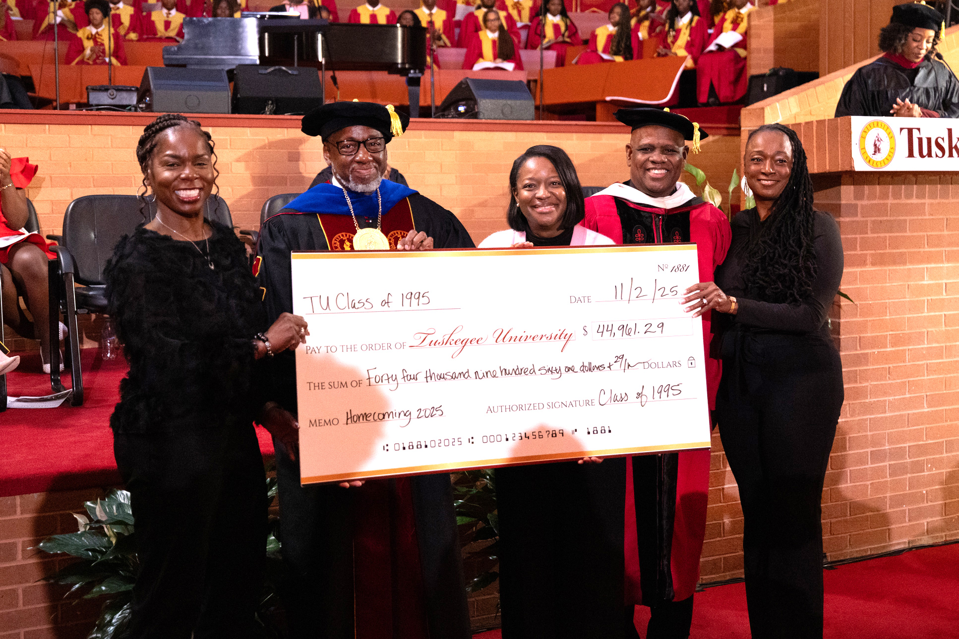 Alumni Class check presentation during Homecoming Convocation